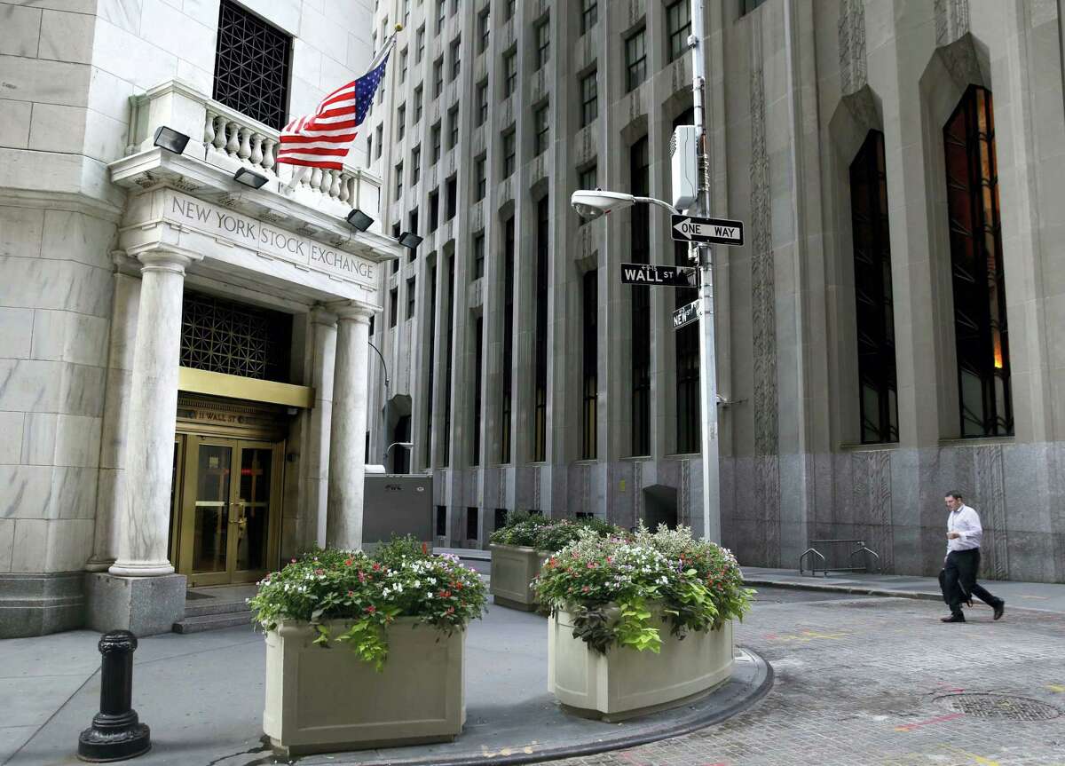 A man walks towards the New York Stock Exchange.