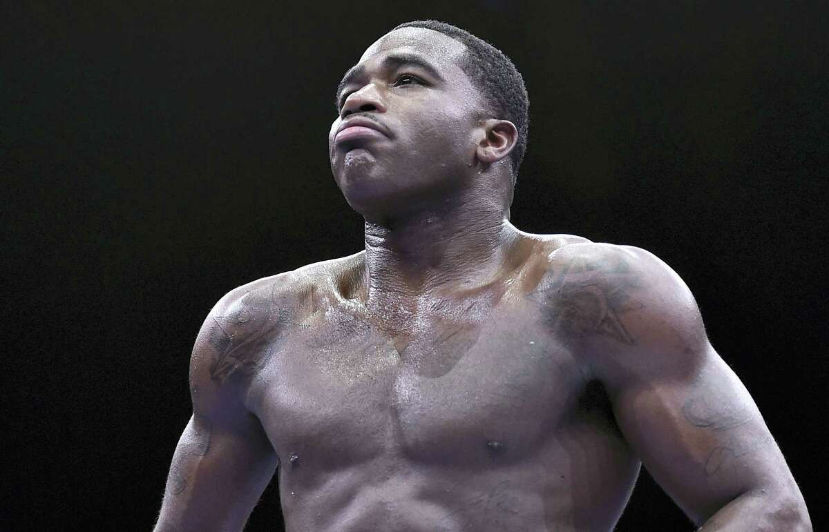 In this June 20, 2015 photo, Adrien Broner walks back to his corner during his welterweight boxing bout against Shawn Porter in Las Vegas.
