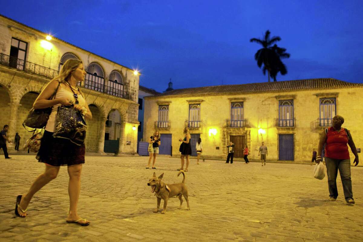 A dog mingles with tourists and Cubans in Cathedral Square in Old Havana, Cuba on March 18, 2016. U.S. President Barack Obama will visit the communist island on March 20. During his three-day trip, the first to the country by a sitting U.S. president in nearly 90 years, he will meet with President Raul Castro at the Palace of the Revolution and attend an exhibition baseball game.