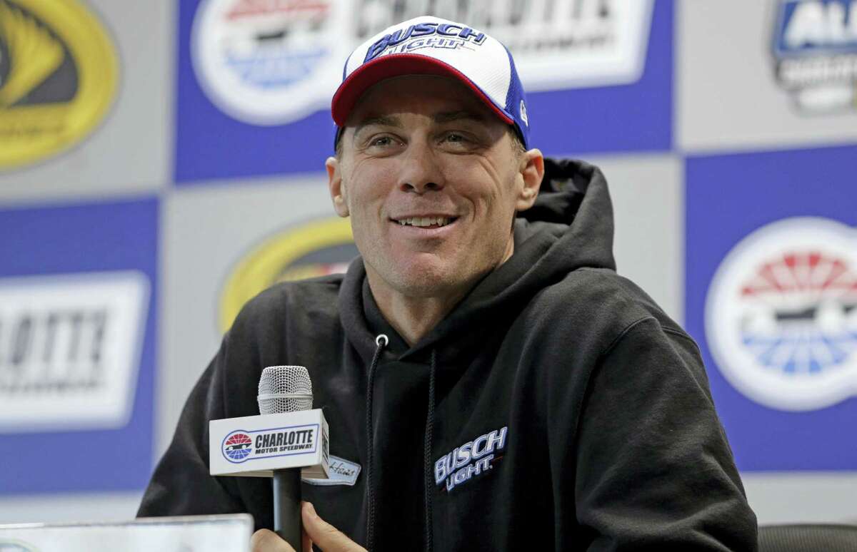 Kevin Harvick smiles as he answers a question during a news conference at Charlotte Motor Speedway in Concord, N.C., on Friday.