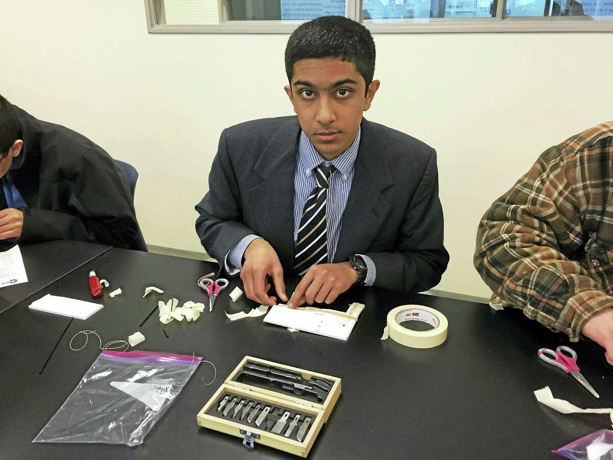 Xavier High School junior Mihir Khunte of Haddam makes a prototype prosthetic hand out of foam board and rubber bands Jan. 15 at Quinnipiac University.