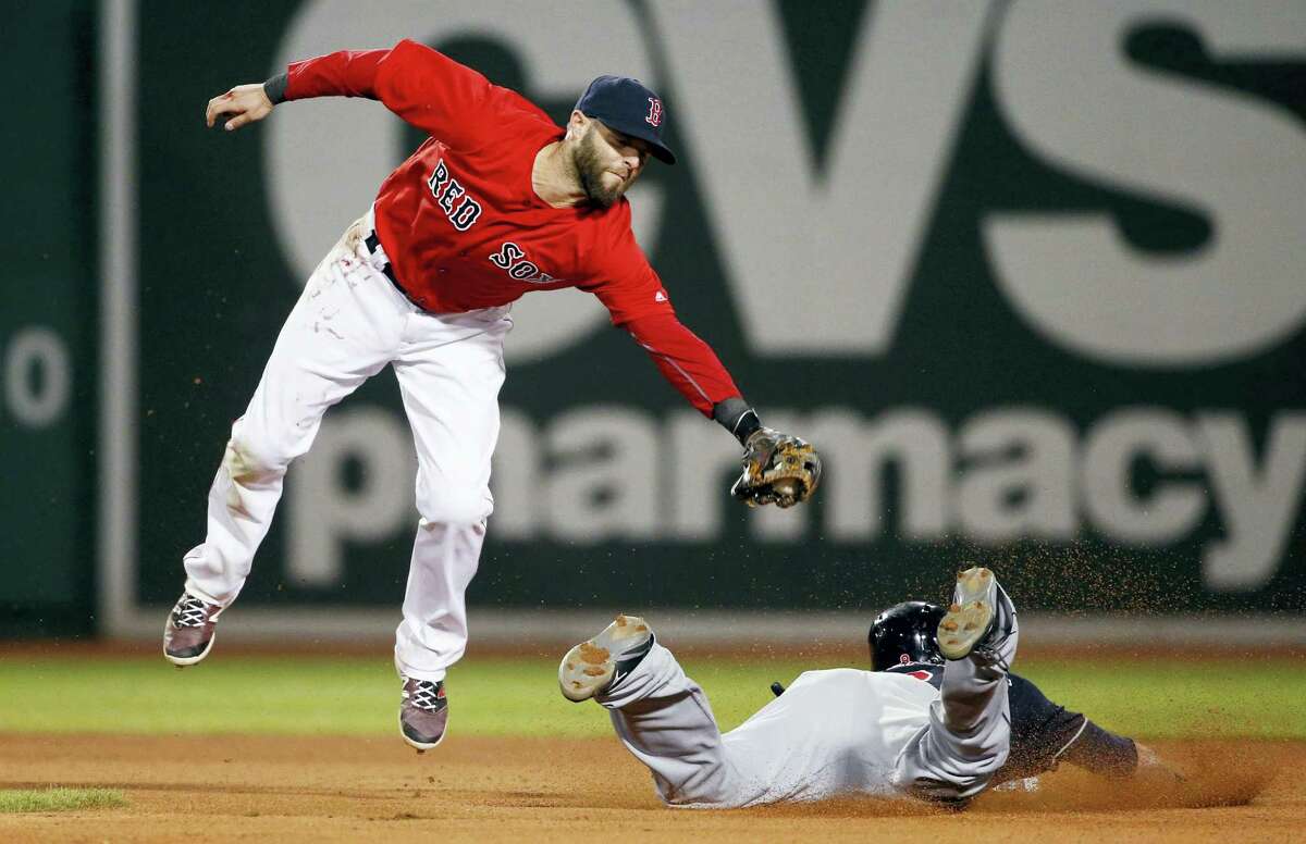 The Indians’ Lonnie Chisenhall steals second base as Dustin Pedroia comes up short on the tag during the eighth inning Friday.