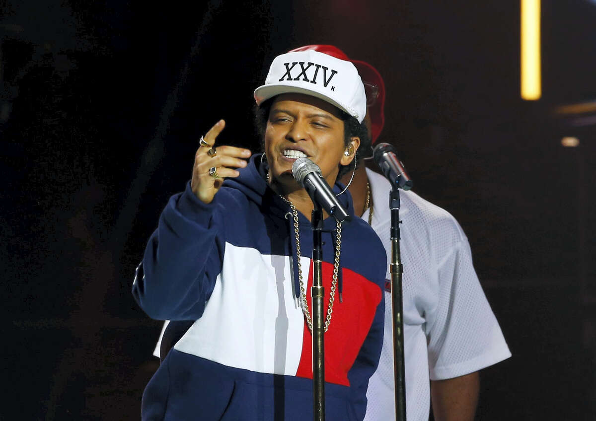 In this Nov. 6, 2016 photo, Bruno Mars performs during the MTV European Music Awards 2016, in Rotterdam, Netherlands. With new albums to promote, timing is perfect for the American Music Awards Sunday, Nov. 20, where performers include top pop stars such as Lady Gaga, Bruno Mars and the Weeknd.