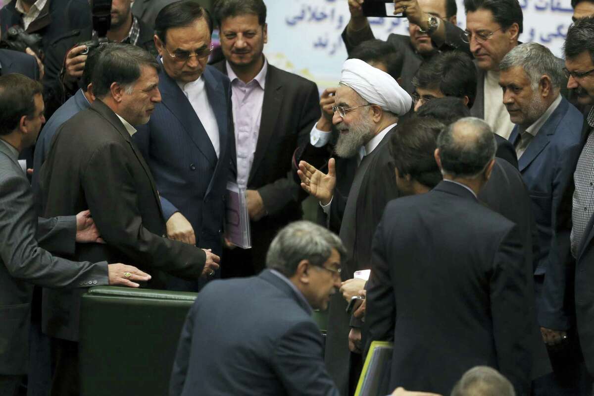 Iranian President Hassan Rouhani, center, gestures as he is greeted by lawmakers at the parliament to present draft of the country’s next year budget and sixth development plan in Tehran, Iran on Jan. 17, 2016.