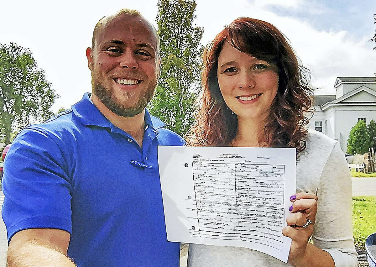 Get Hitched at the Durham Fair contest winners Ken Murphy and Shelby Aiello display the wedding license they received in Durham earlier this week. The couple will wed Sunday at the 97th annual agricultural celebration.