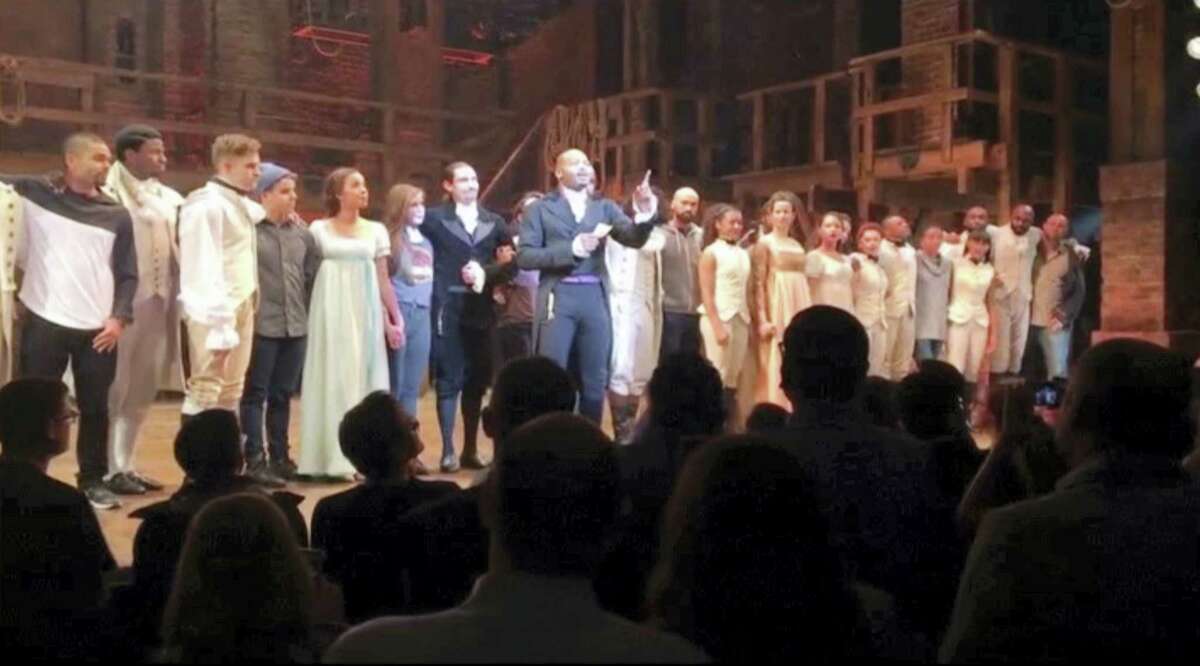 In this image made from a video provided by Hamilton LLC, actor Brandon Victor Dixon, who plays Arron Burr, the nation’s third vice president, in “Hamilton” speaks from the stage after the curtain call in New York, Friday, Nov. 18, 2016. Vice President-elect Mike Pence is the latest celebrity to attend the Broadway hit “Hamilton,” but the first to get a sharp message from a cast member from the stage.