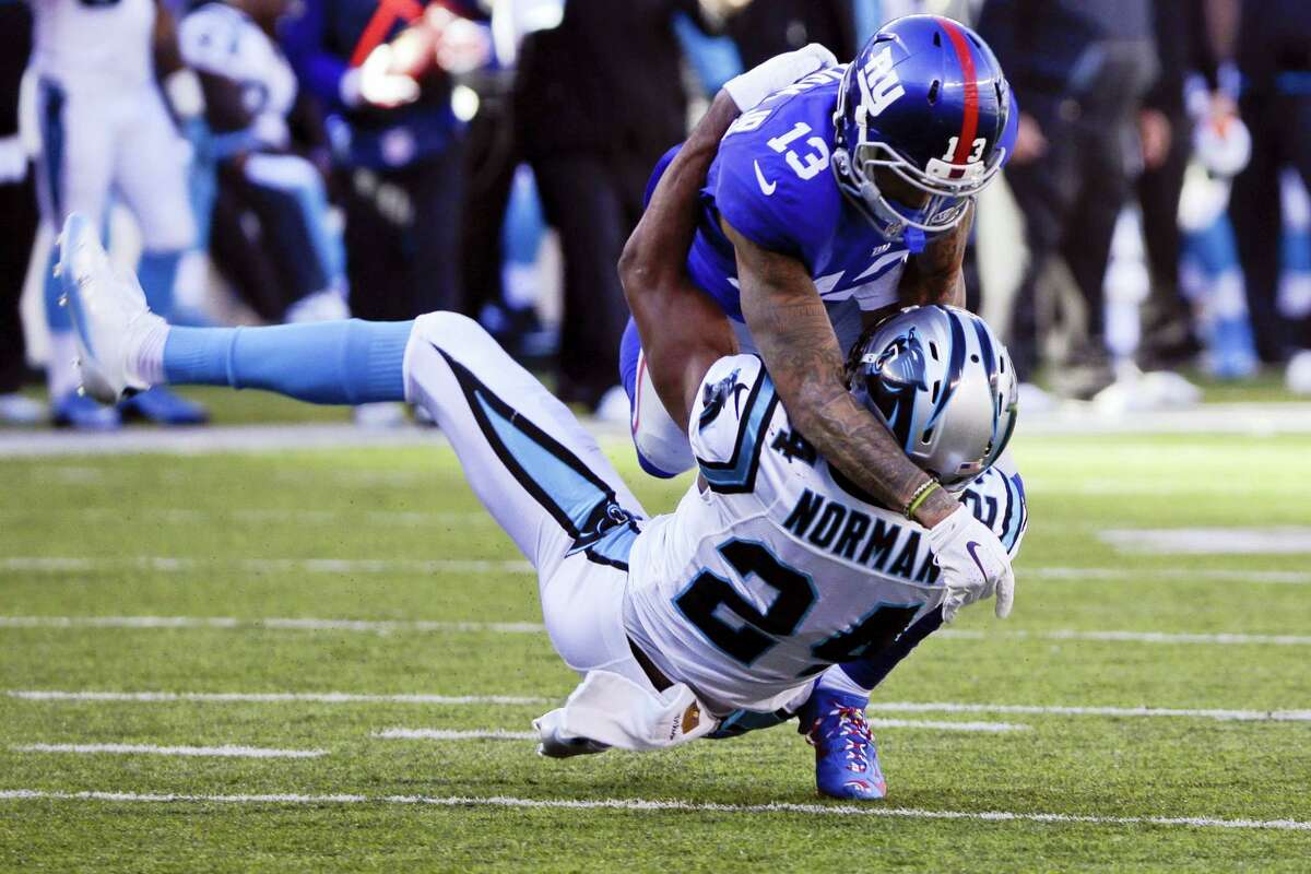 New York Giants wide receiver Odell Beckham (13) and Carolina Panthers’ Josh Norman (24) grapple during the first half of last year’s game at MetLife Stadium.