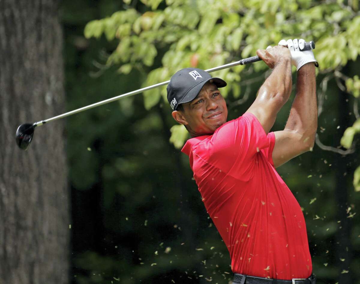 In this Aug. 23, 2015, file photo, Tiger Woods watches his tee shot on the second hole during the final round of the Wyndham Championship golf tournament. Woods withdrew from the PGA Championship Tuesday, the first time he will go an entire year without playing a major. He will miss the remainder of the PGA Tour season.