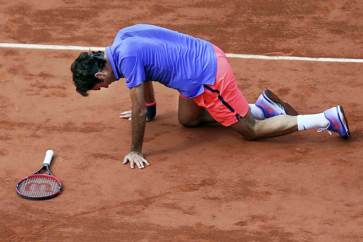FILE- In this June 2, 2015 file photo, Switzerland’s Roger Federer gets up after slipping in the quarterfinal match of the French Open tennis tournament against Switzerland’s Stan Wawrinka at the Roland Garros stadium, in Paris, France. Swiss star Roger Federer has pulled out of the French Open because of concerns over the risk of injury.