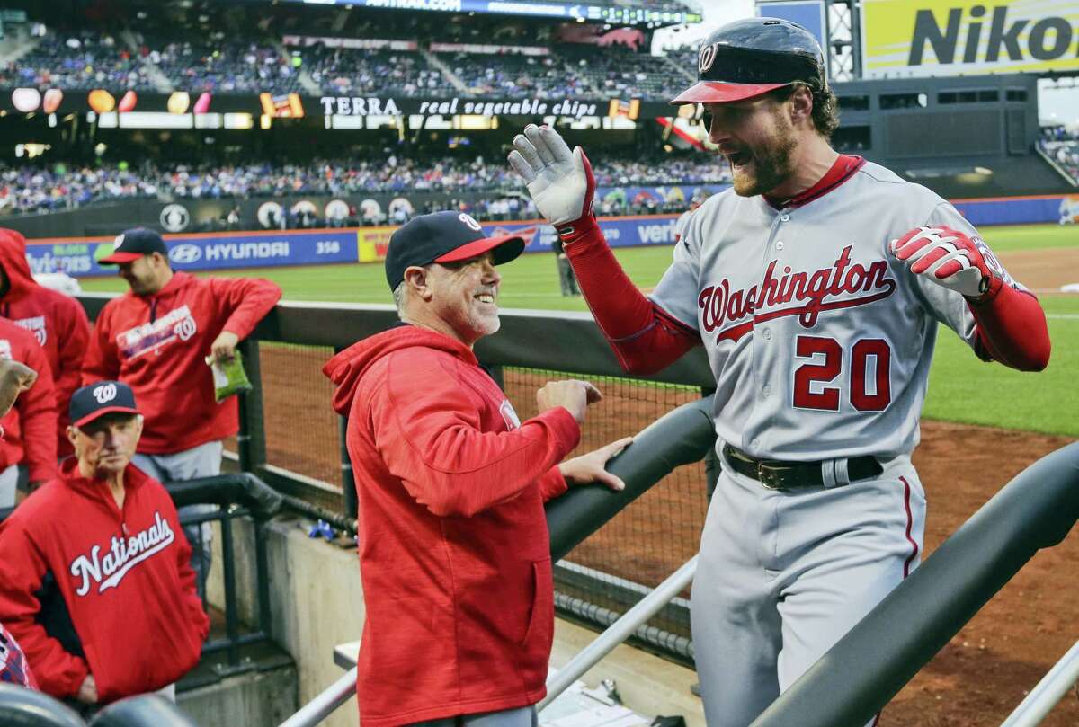 Washington Nationals’ Daniel Murphy celebrates with teammates after hitting a two-run home run during the first inning against the New York Mets in New York. The Nationals routed the Mets 9-1.