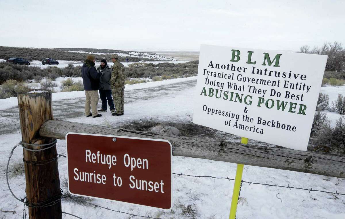 In this Monday, Jan. 4, 2016, file photo, Members of the group occupying the Malheur National Wildlife Refuge headquarters stand guard near Burns, Ore. Thousands of archeological artifacts and maps detailing where more can be found are stored at a national wildlife refuge currently being held by a group of armed protestors.