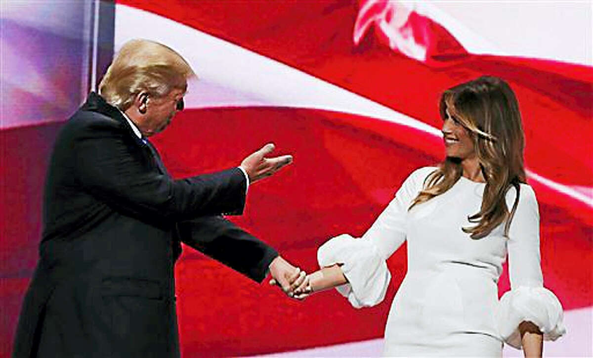 Republican presidential candidate Donald Trump, right, acknowledges his wife, Melania, as they walk off stage during the Republican National Convention, Monday, July 18, 2016, in Cleveland.