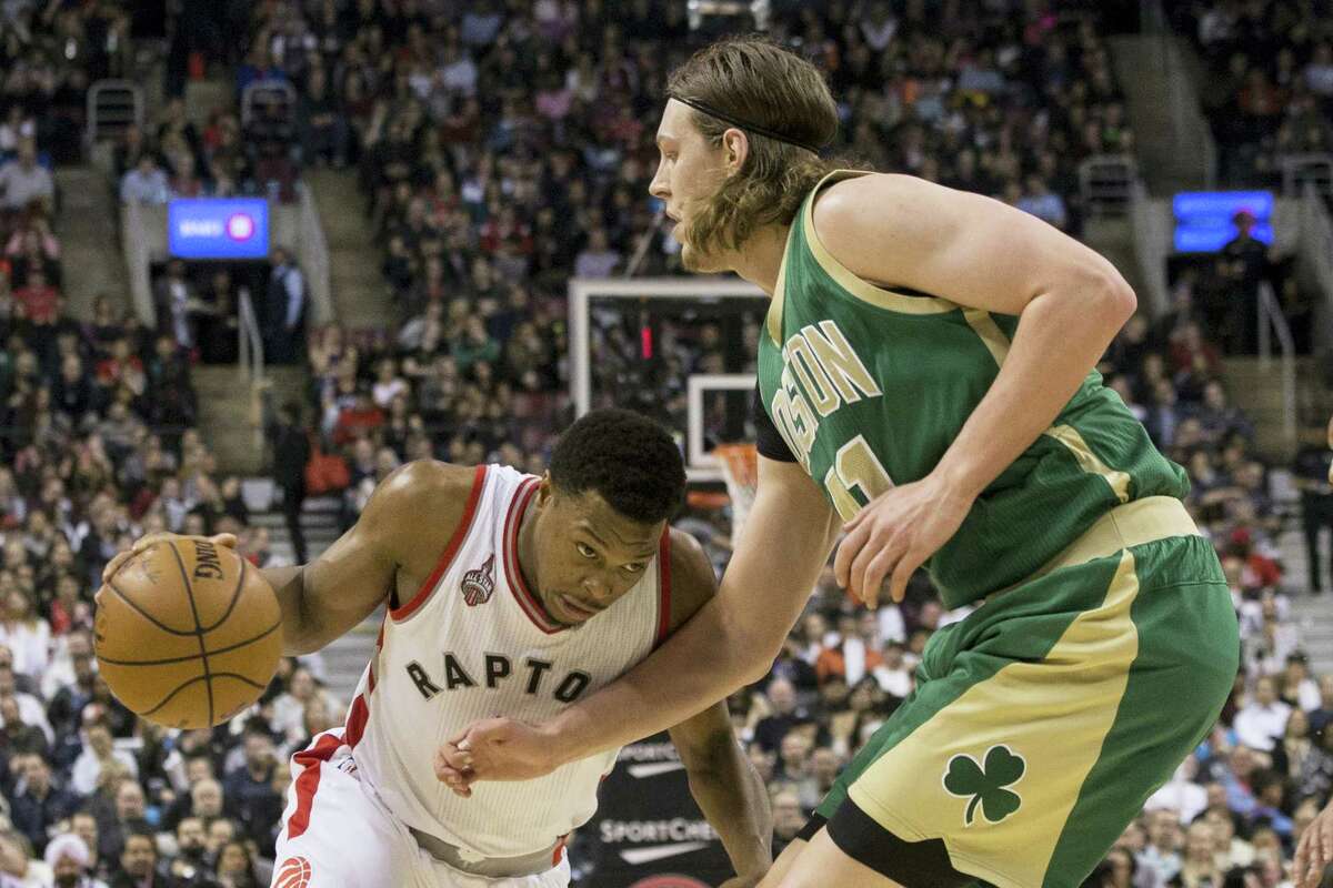 Toronto Raptors’ Kyle Lowry, left, drives against Boston Celtics’ Kelly Olynyk during second-half action in Toronto, Friday.