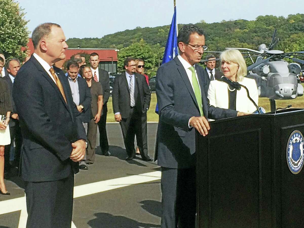 From left, Sikorsky Aircraft President Dan Schultz, Gov. Dannel Malloy and state Department of Economic and Community Development Commissioner Catherine Smith discuss the state’s deal with the helicopter maker at a press conference in Stratford Wednesday. A model of the CH-53K, a new helicopter Sikorsky will build in Connecticut, is shown at far right.