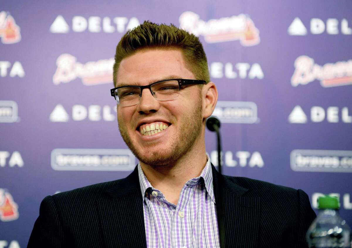 Atlanta Braves first baseman Freddie Freeman smilies as he announces that he has agreed to terms with the team that will keep him in a Braves uniform for eight years on Feb. 5, 2014 in Atlanta.
