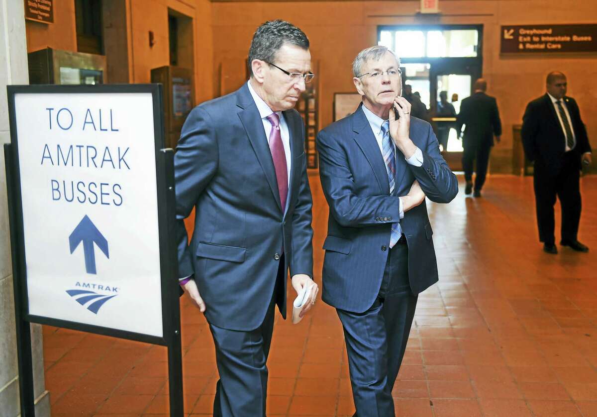 Gov. Dannel P. Malloy, left, confers with Connecticut Department of Transportation Commissioner James Redeker at Union Station in New Haven. The governor and the General Assembly are pushing the adoption of a state constitutional amendment to establish a lockbox for transportation tax revenue.