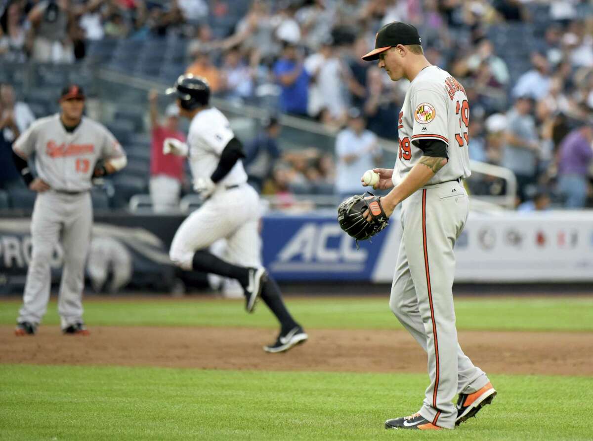Orioles pitcher Kevin Gausman, right, reacts as Alex Rodriguez rounds the bases after hitting a home run in the second inning on Monday.