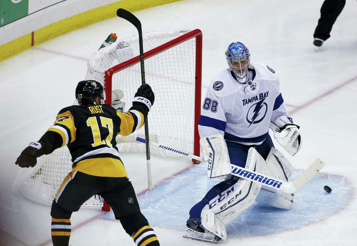 Pittsburgh Penguins' Bryan Rust (17) celebrates the winning goal by Sidney Crosby past Tampa Bay Lightning goalie Andrei Vasilevskiy during the overtime period of Game 2 of the NHL hockey Stanley Cup Eastern Conference finals, Monday, May 16, 2016, in Pittsburgh. The Penguins won 3-2. (AP Photo/Gene J. Puskar)