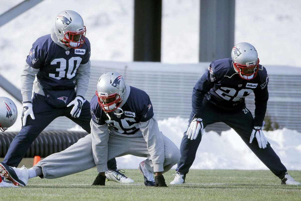 New England Patriots, front the left, cornerback Duron Harmon, defensive end Chandler Jones, and cornerback Logan Ryan warm up during an NFL football practice, Wednesday, Jan. 13, 2016, in Foxborough, Mass. The Patriots are to host the Kansas City Chiefs in an NFL divisional playoff game Jan. 16, 2016, in Foxborough.
