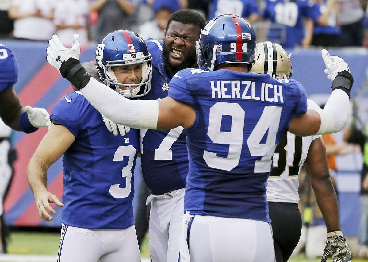 Giants kicker Josh Brown (3) celebrates with Mark Herzlich (94) and John Jerry after making the winning field goal on Sunday.