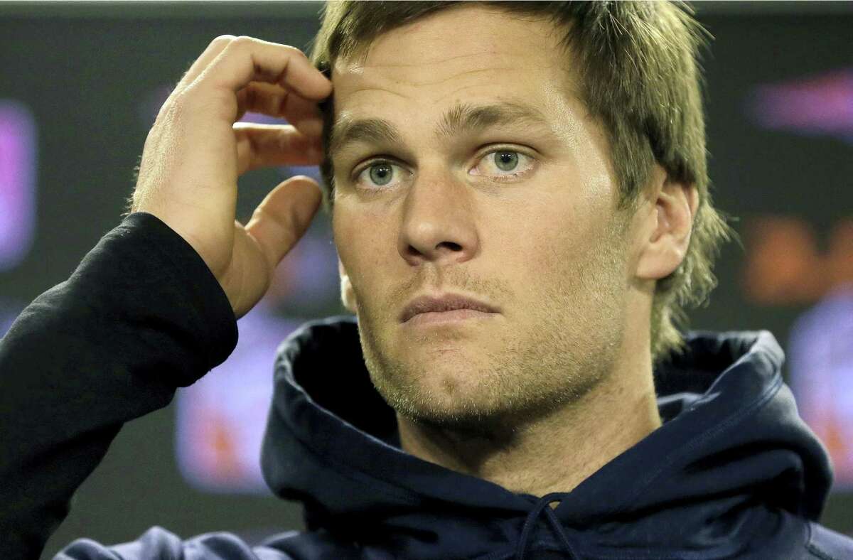 New England Patriots quarterback Tom Brady faces reporters before a scheduled NFL football practice in Foxborough, Mass. Brady said on Friday he will not ask the U.S. Supreme Court to block his four-game “Deflategate” suspension, ending his fight.
