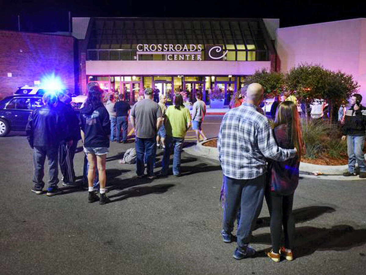 People stand near the entrance on the north side of Crossroads Center mall between Macy’s and Target as officials investigate a reported multiple stabbing incident on Sept. 17, 2016, in St. Cloud, Minn. Police said multiple people were injured at the St. Cloud shopping mall on Saturday evening in an attack possibly involving both shooting and stabbing. The suspect is believed to be dead, St. Cloud Police Sgt. Jason Burke told the St. Cloud Times.