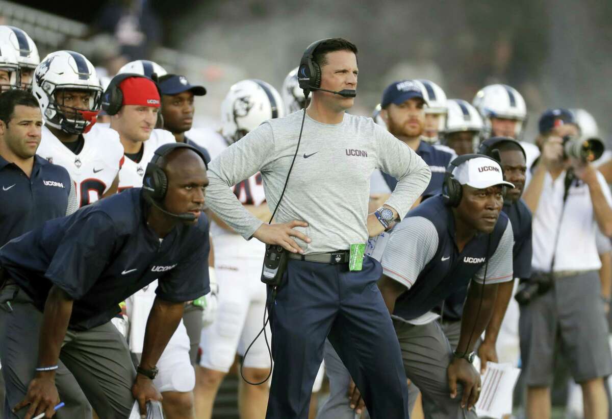 Connecticut head coach Bob Diaco, center, stands on the sideline in the second half of an NCAA college football game against Navy in Annapolis, Md., Saturday, Sept. 10, 2016. (AP Photo/Patrick Semansky)