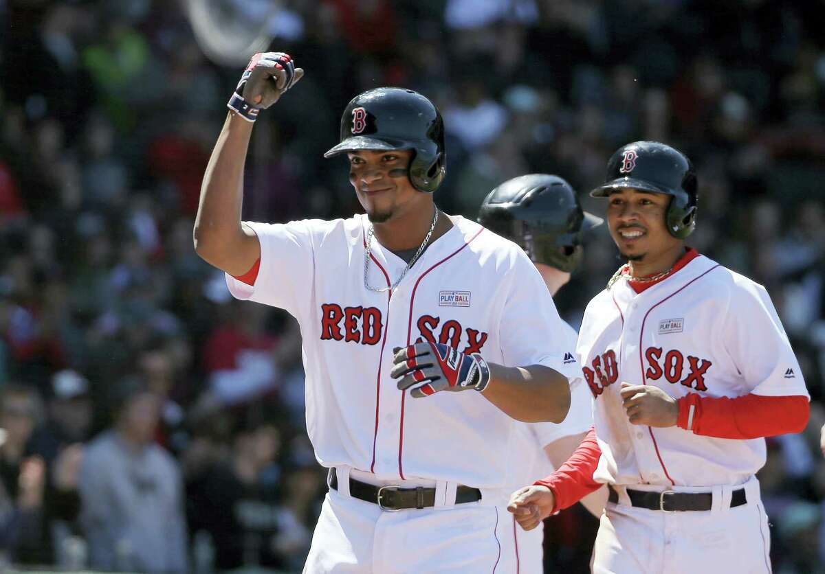 Xander Bogaerts, left, celebrates his three-run home run in the second inning Sunday against the Astros.