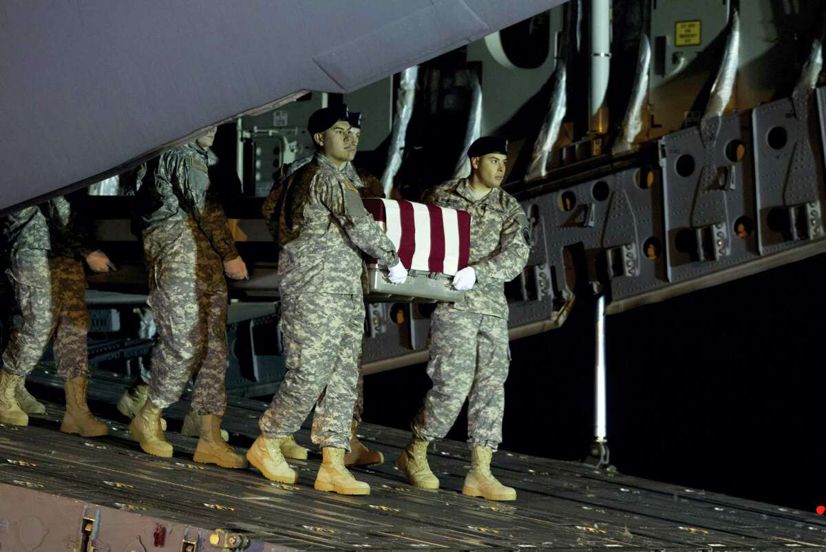 An Army team carries the transfer case containing the remains of Army Staff Sgt. Matthew Q. McClintock of Bernalillo, New Mexico, upon arrival at Dover Air Force Base, Delaware, on Friday. The Department of Defense announced the death of McClintock, who was supporting Operation Freedom’s Sentinel in Afghanistan.