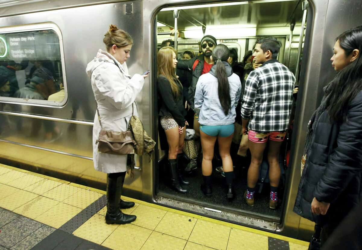 The doors of a subway train open revealing pantless riders in colorful underwear during the 15th annual No Pants Subway Ride Sunday in New York. The group event has been going on since 2002.