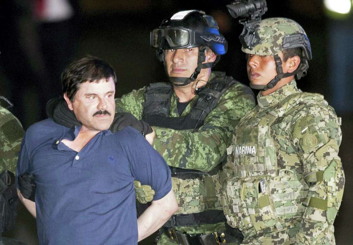 Joaquin “El Chapo” Guzman is made to face the press as he is escorted to a helicopter in handcuffs by Mexican soldiers and marines at a federal hangar in Mexico City, Mexico on Jan. 8, 2016. Mexican President Enrique Pena Nieto announced that Guzman had been recaptured six months after escaping from a maximum security prison.