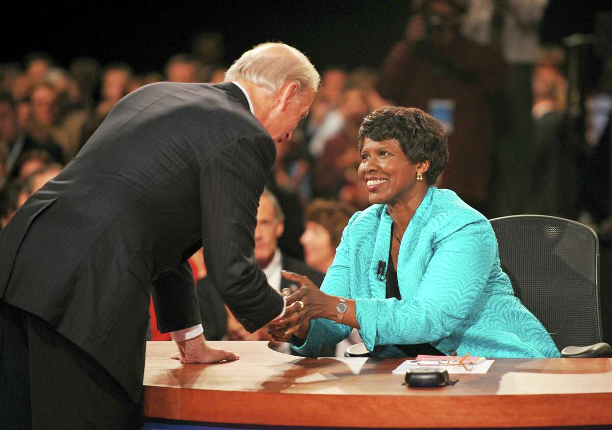 In this file photo, PBS journalist and debate moderator Gwen Ifill and then-Democratic vice presidential nominee, Sen. Joe Biden, D-Del., left, shake hands at the end of his vice presidential debate with Republican rival, Alaska Gov. Sarah Palin in St. Louis, Mo. Ifill died on Monday of cancer, PBS said. She was 61.