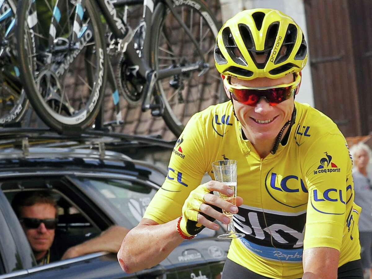This is a Sunday, July 24, 2016 photo of Britain’s Chris Froome, wearing the overall leader’s yellow jersey, celebrates with a glass of champagne during the twenty-first stage of the Tour de France in Paris. Three-time Tour de France winner Chris Froome said on Sept. 15, 2016 he has “no issue” with his medical data being leaked, in an alleged criminal attack by Russian hackers on a World Anti-Doping Agency database.
