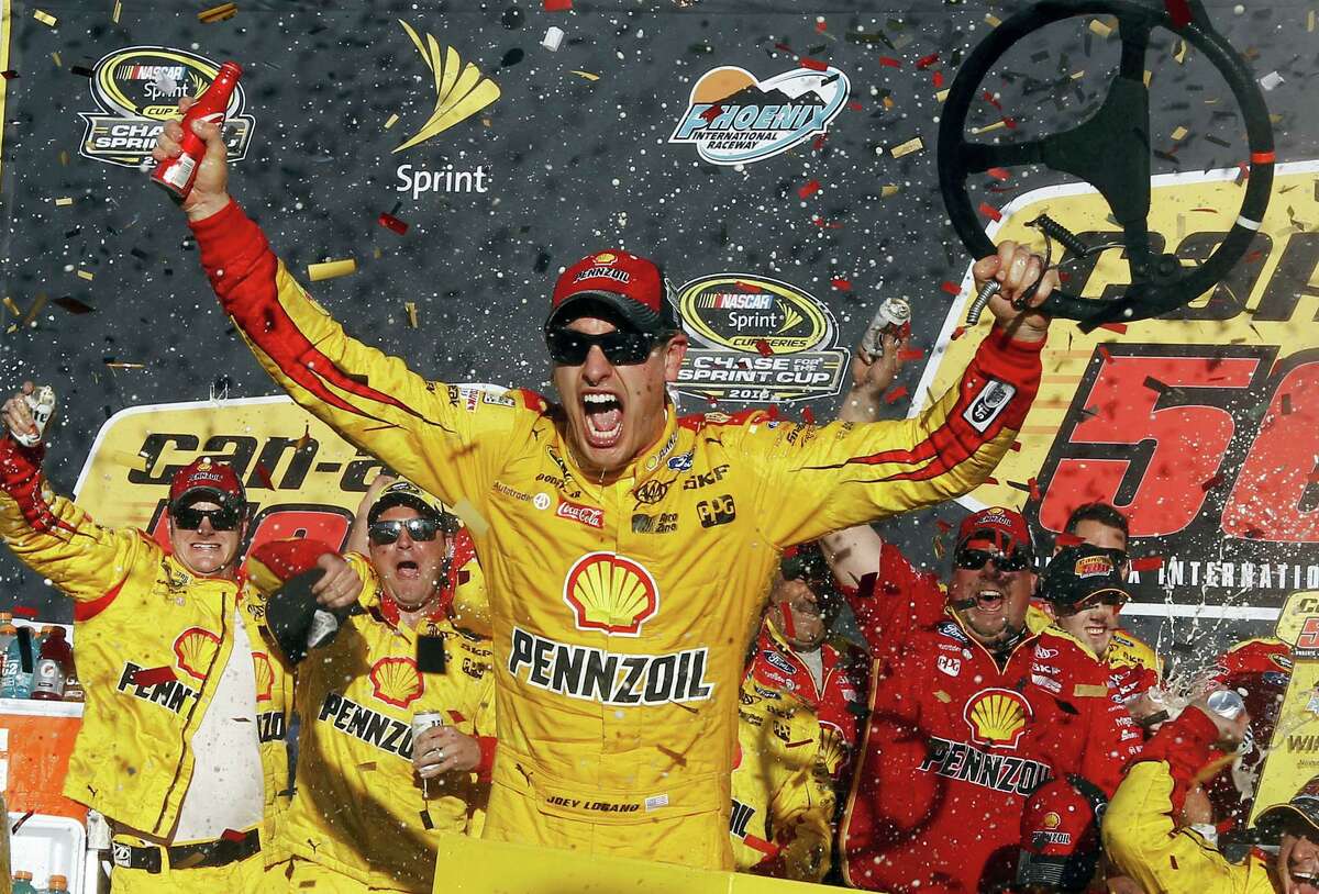 Joey Logano celebrates in the victory lane after winning the NASCAR Sprint Cup Series race at Phoenix International Raceway Sunday in Avondale, Ariz.