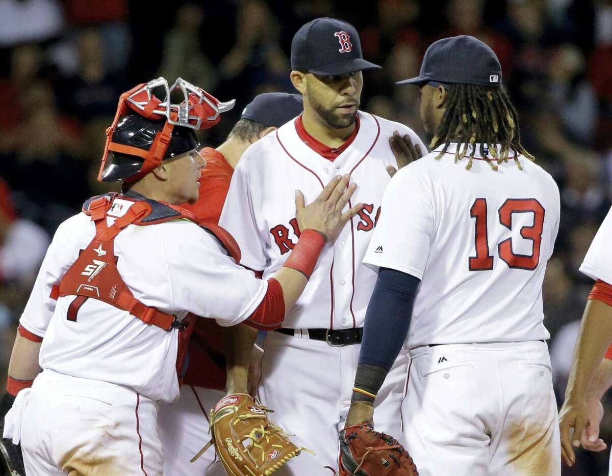 Boston Red Sox starting pitcher David Price receives pats from catcher Christian Vazquez (7) and first baseman Hanley Ramirez (13) as he is taken out during the seventh inning of a baseball game against the Houston Astros at Fenway Park, Thursday, May 12, 2016, in Boston. (AP Photo/Elise Amendola)