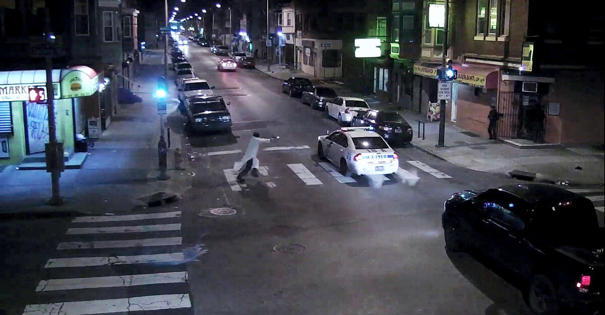 In this frame from a Thursday, Jan. 7, 2016 video provided by the Philadelphia Police Department, Edward Archer runs with a gun toward a police car driven by Officer Jesse Hartnett in Philadelphia. Archer, using a gun stolen from police, said he was acting in the name of Islam when he ambushed Hartnett sitting in his marked cruiser at an intersection, firing shots at point-blank range, authorities said.