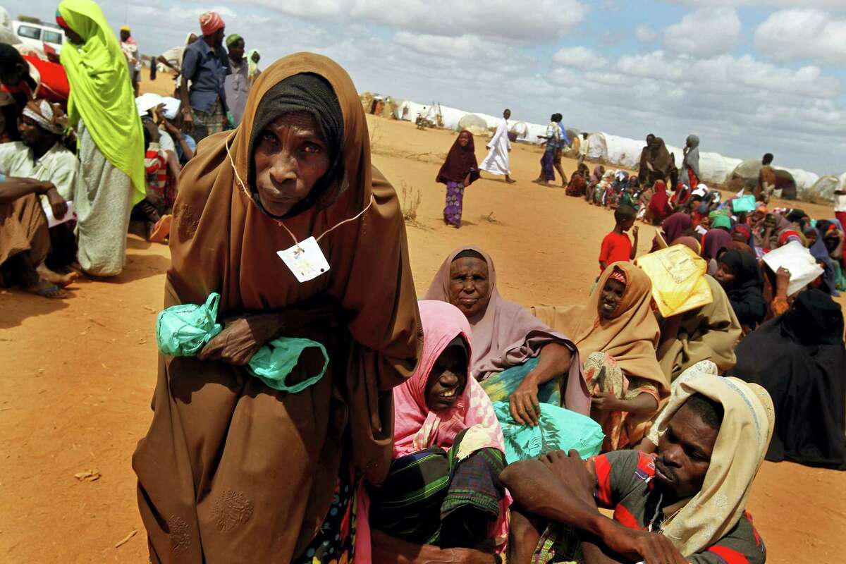 In this Friday Aug. 5, 2011 file photo, Somali refugees walk through an area housing new arrivals, on the outskirts of Hagadera Camp outside Dadaab, Kenya. Nobel laureate Malala Yousafzai is spending her 19th birthday in Kenya Tuesday July 12, 2016, visiting the world’s largest refugee camp to draw attention to the global refugee crisis, especially as Dadaab camp faces pressure to close after a quarter-century.