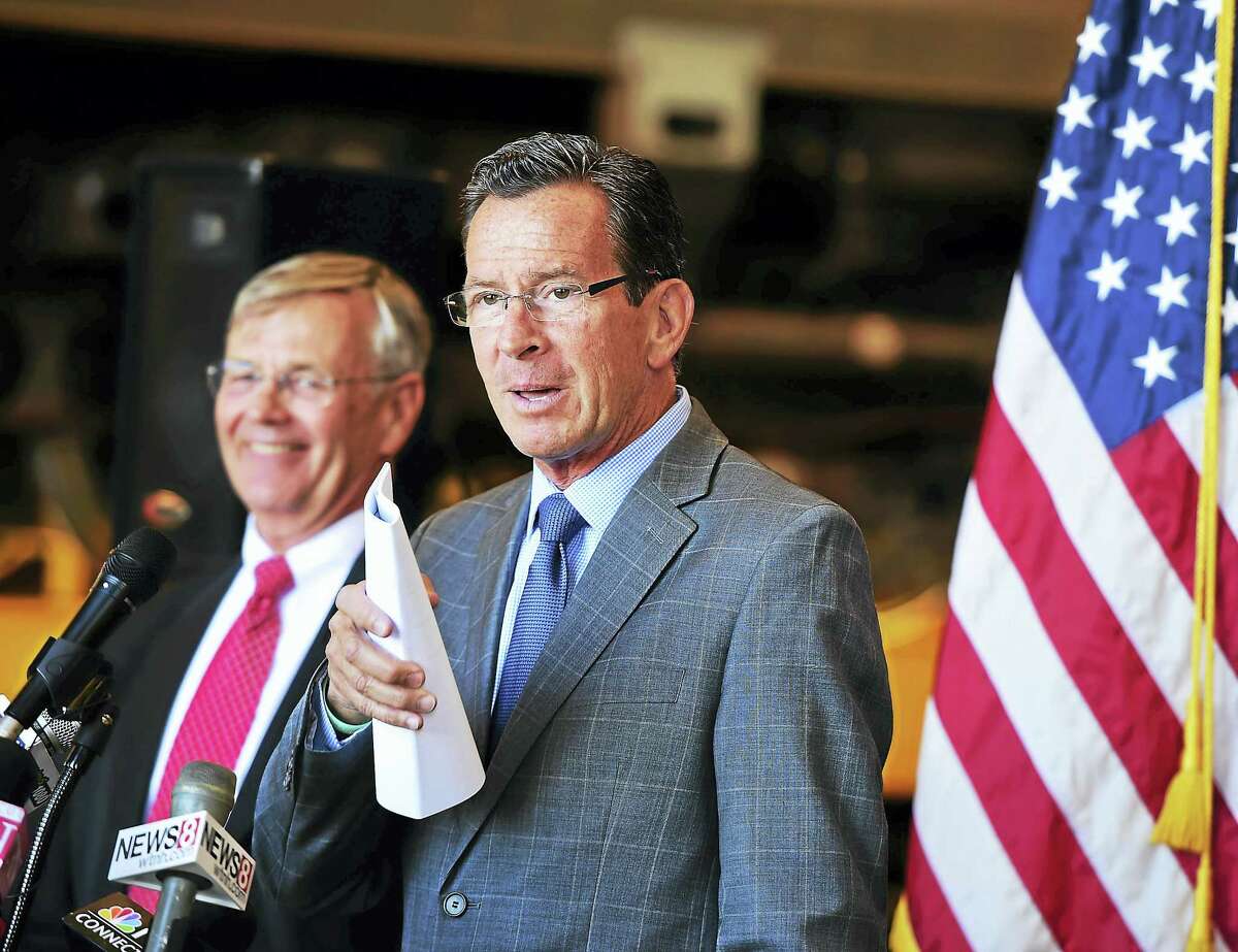Gov. Dannel P. Malloy, right, and Connecticut Department of Transportation Commissioner James P. Redeker announce the purchase of 60 M8 rail cars for the New Haven Line operated by Metro-North Railroad, during a press conference Tuesday at the New Haven Rail Yard on Brewery Street.