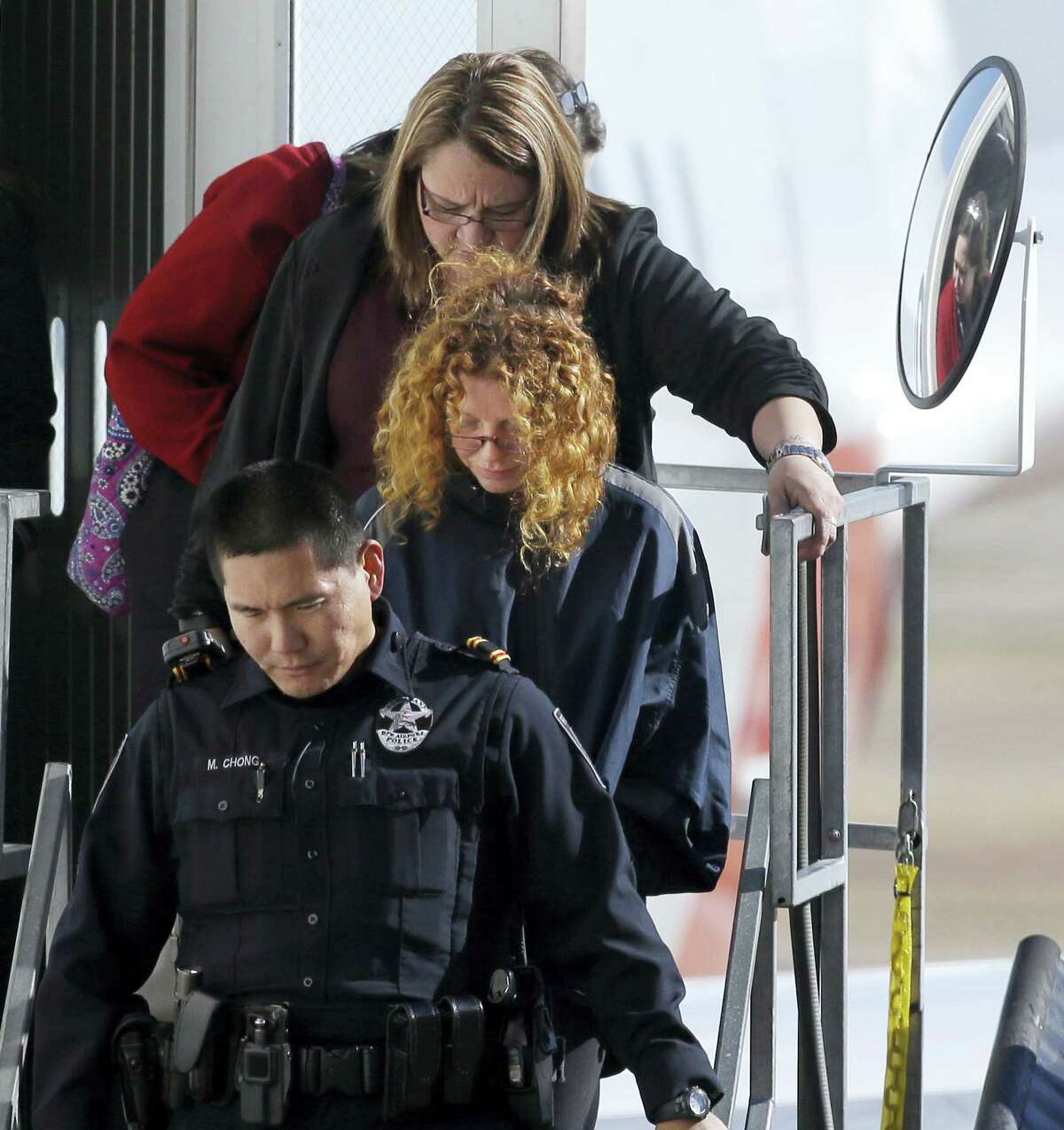 Tonya Couch is escorted off a flight after her arrival to the Dallas/Fort Worth International Airport in Grapevine, Texas, Thursday, Jan. 7, 2016. Couch, mother of a fugitive teenager known for using an “affluenza” defense in a deadly drunken-driving case, waived extradition and was sent to Texas from California to face a charge of hindering the apprehension of a felon.