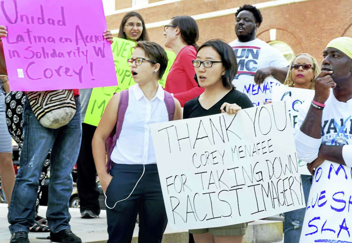 Linda Xing, a Yale University student at Calhoun College, center with sign, and others rally at Superior Court on Elm Street in New Haven Tuesday.