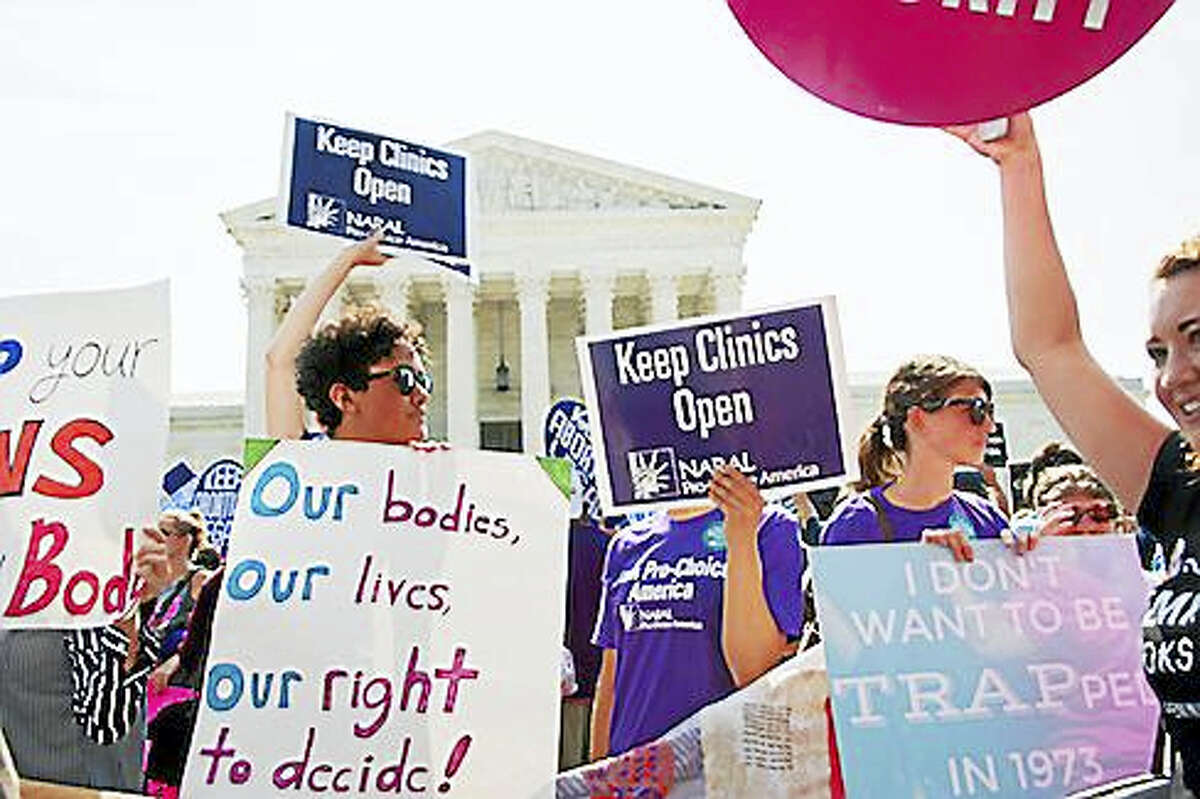 A pro-choice activist holds a Planned Parenthood sign while awaiting the Supreme Court’s ruling on abortion access in front of the Supreme Court in Washington on June 27.
