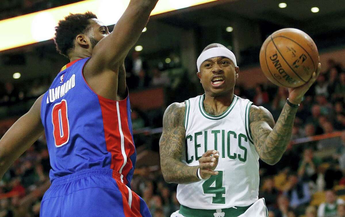 Boston Celtics' Isaiah Thomas (4) passes off in front of Detroit Pistons' Andre Drummond (0) during the first quarter of an NBA basketball game in Boston, Wednesday, Jan. 6, 2016. (AP Photo/Michael Dwyer)