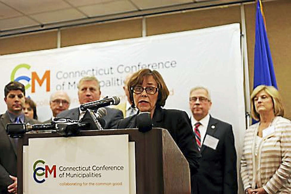 CHRISTINE STUART PHOTO Portland First Selectwoman Susan Bransfield, vice president of the Connecticut Conference of Municipalities, speaks during a press conference in Cromwell Tuesday. At far left is Middletown Mayor Dan Drew.