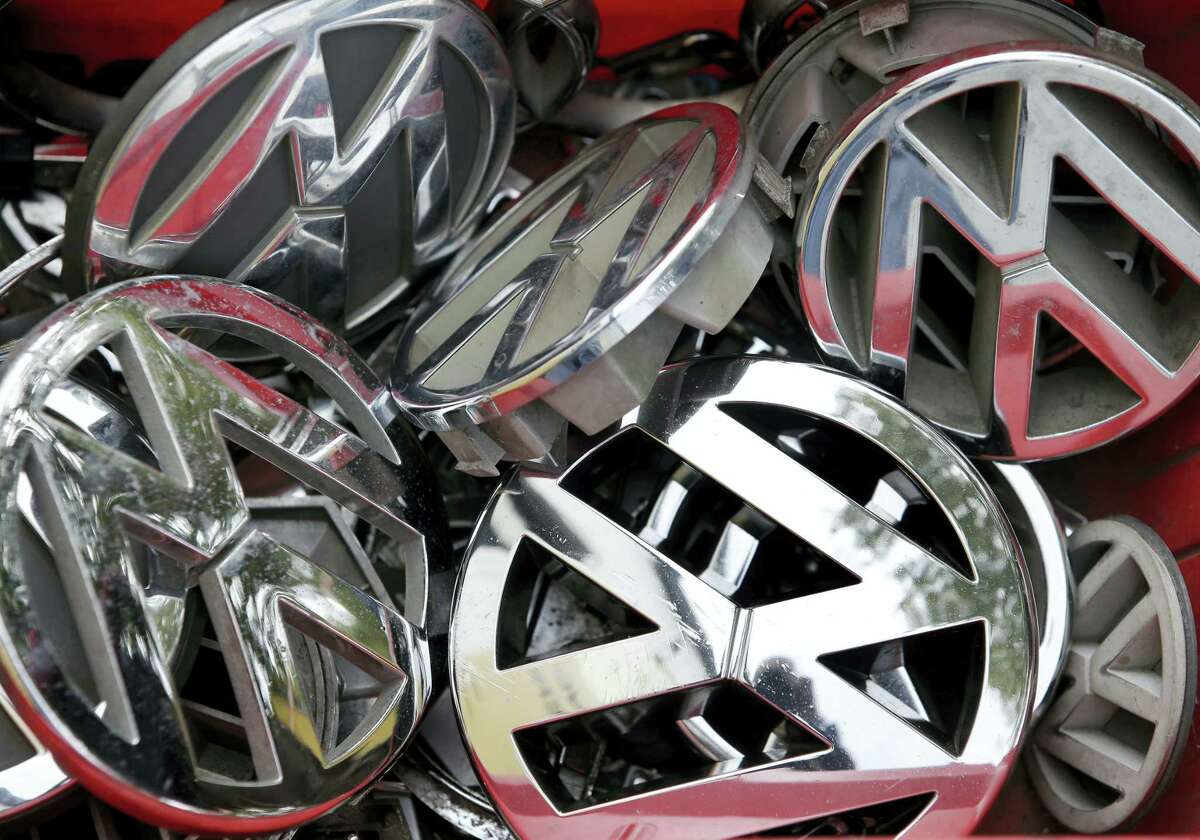 In this Sept. 23, 2015 photo, Volkswagen ornaments sit in a box in a scrap yard in Berlin, Germany.
