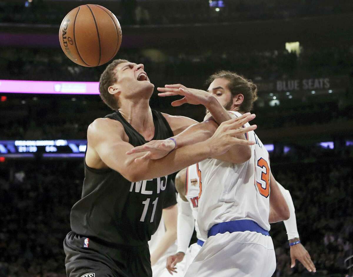 Brooklyn Nets’ Brook Lopez (11) and New York Knicks’ Joakim Noah compete for control of the ball during the first half of Wednesday’s victory for the Knicks.