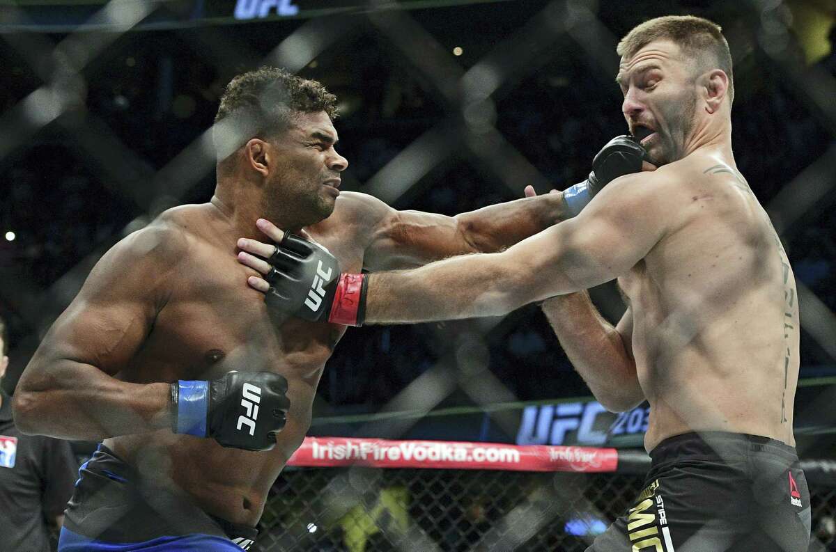 Alistair Overeem, left, from the Netherlands, punches Stipie Miocic during a heavyweight title bout at UFC 203 on Sept. 10, 2016 in Cleveland.