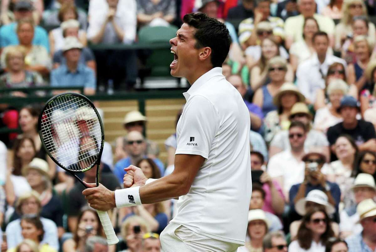 Milos Raonic of Canada celebrates after beating Roger Federer of Switzerland in their men’s semifinal singles match at Wimbledon.
