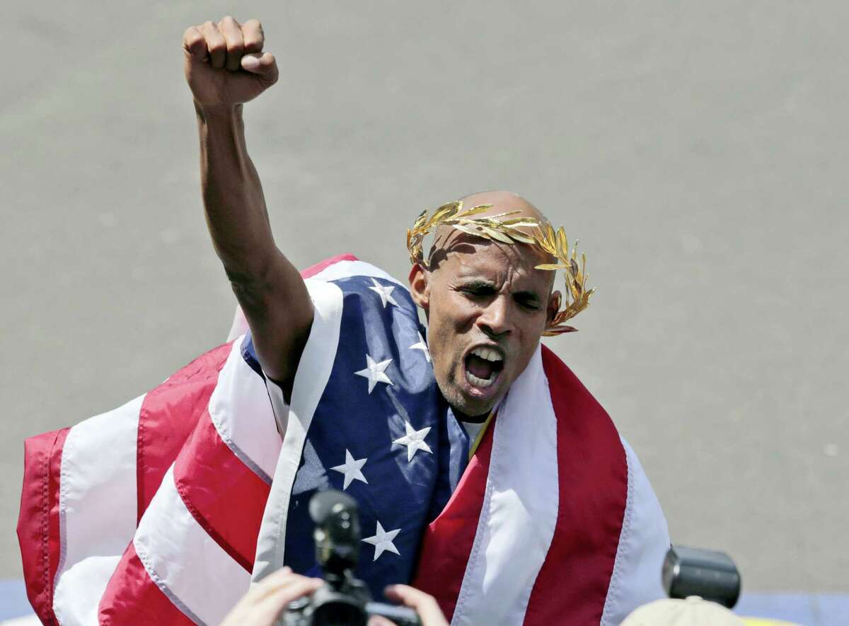 In this 2014 file photo, Meb Keflezighi celebrates his victory in the 118th Boston Marathon. Keflezighi was the first American man to win the race in 31 years. The first feature-length documentary film highlighting historical moments of the nation’s oldest marathon is in the works, tentatively set to premiere in April 2017 in conjunction with the 121st running of the race.