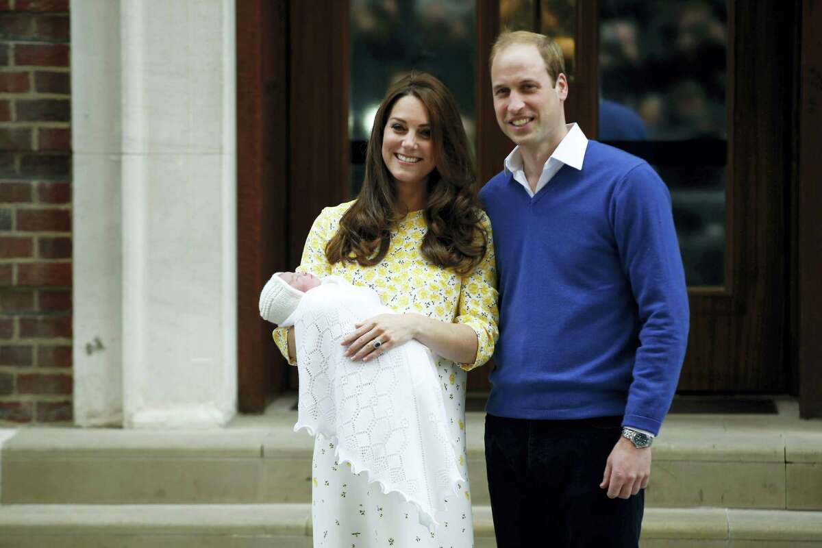 Britain’s Prince William, right, and Kate, Duchess of Cambridge, hold their newborn daughter as they pose for the media outside the St. Mary’s Hospital’s exclusive Lindo Wing, London on May 2, 2015.