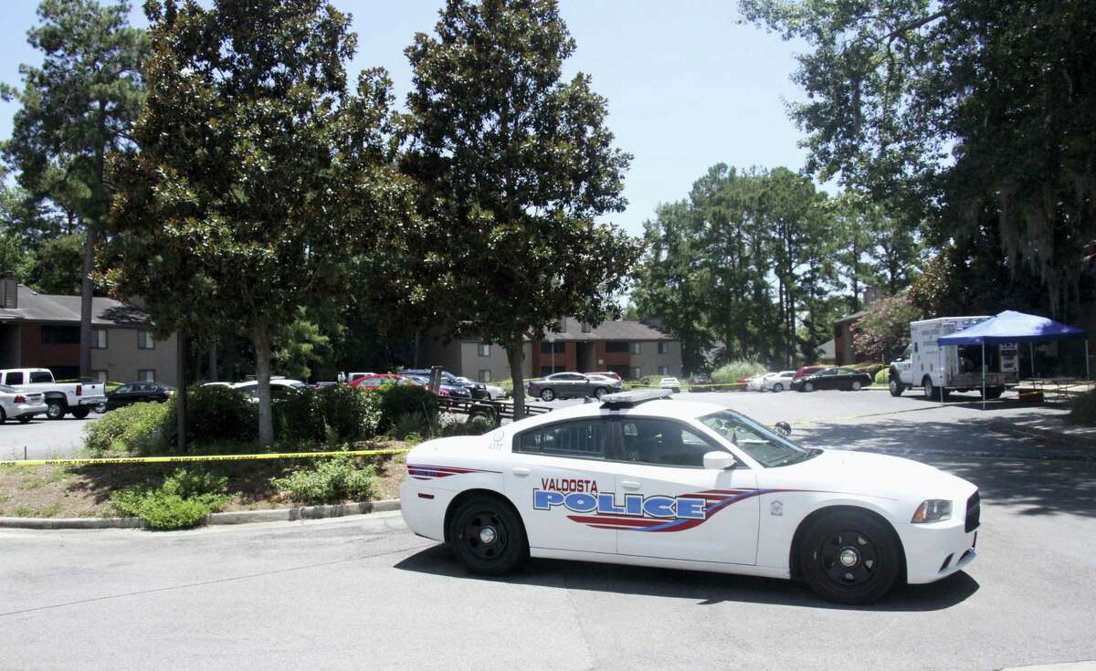 A police vehicle parks near the scene of an officer involved shooting, Friday, July 8, 2016, in Valdosta, Ga. A man who called 911 to report a car break-in Friday ambushed a south Georgia police officer dispatched to the scene, sparking a shootout in which both the officer and suspect were wounded, authorities said. Both are expected to survive.
